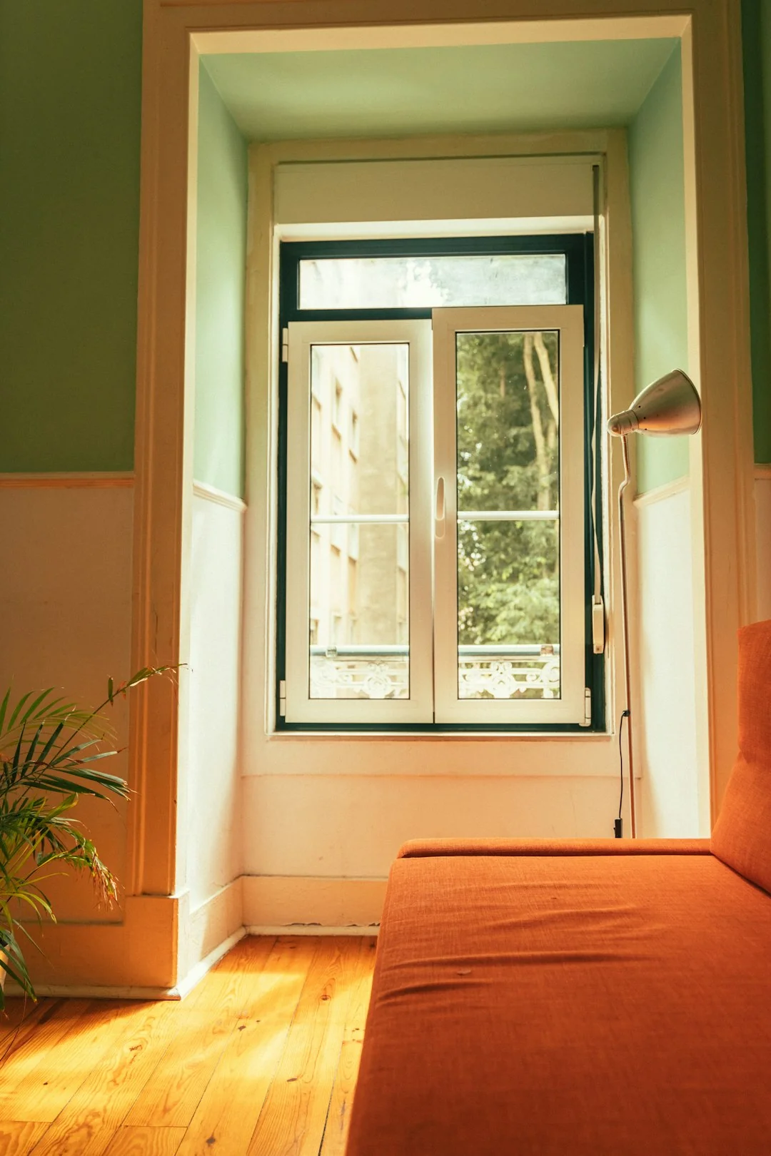 Asian couple enjoying themselves while tidying their home, creating a bright and cheerful mood.